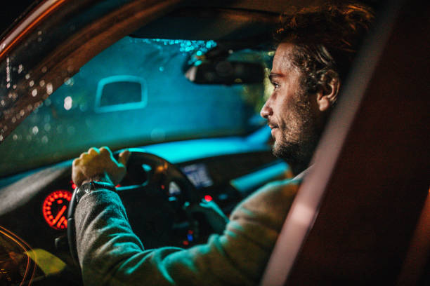 istock Businessman Driving A Car In Night 1175903493