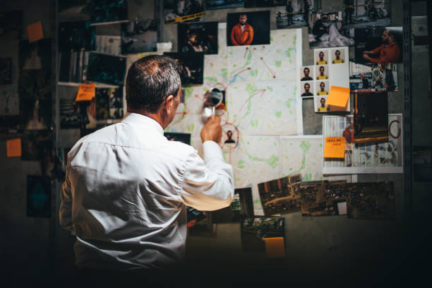 Mature detective working late on a case