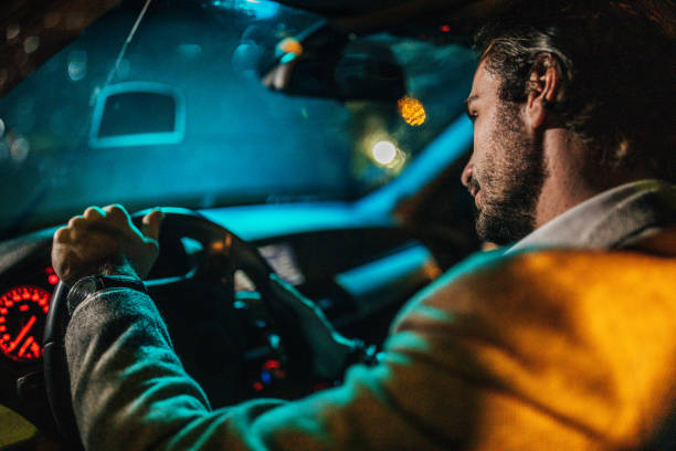 istock Businessman Driving A Car In Night 1175904185