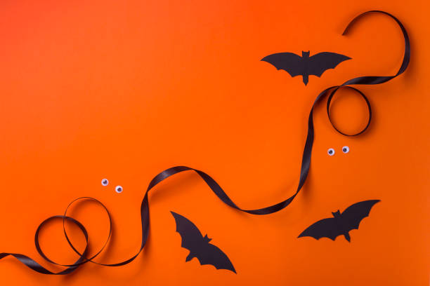 istock Black halloween characters and accessories on a bright orange background 1175904812