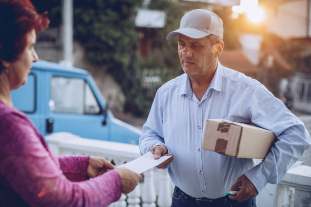 istock The delivery man gives the mail 1175905847