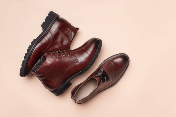 istock Brown women's leather autumn ankle boots on pink background. 1175906003