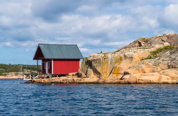 Photo of Red wooden boathouse on a small island near Hovenäset on the west coast of Bohuslän, Sweden