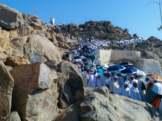 Muslim people visiting Jabal Rahmah (or Mount Arafah) during Hajj MECCA, SAUDI ARABIA - 22-07-2018 : Muslim people visiting Jabal Rahmah (or Mount Arafah) during Hajj and Umrah .Muslim believe to be the place of the first meeting between Adam and Hawa(eve) haji stock pictures, royalty-free photos & images