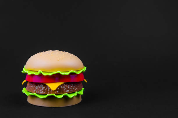 istock fast food. plastic hamburger on a black background 1175910317