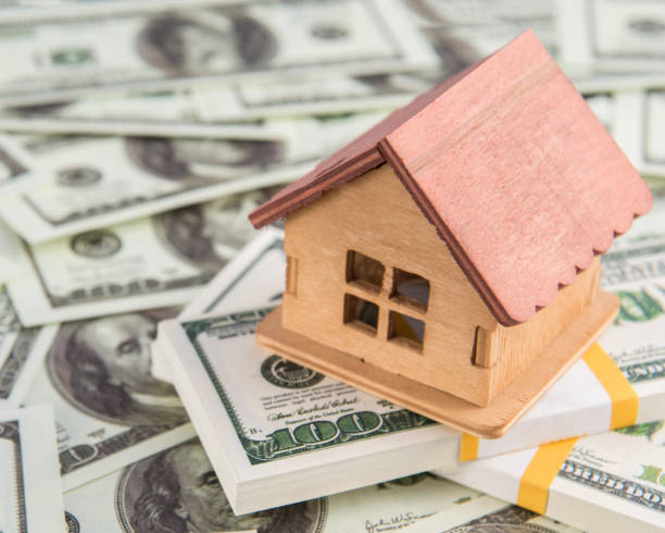 istock House on a bundle of dollar money. 1175911217