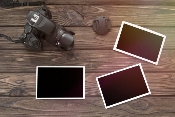 istock photos, a camera on the background of a wooden table. 1175911237