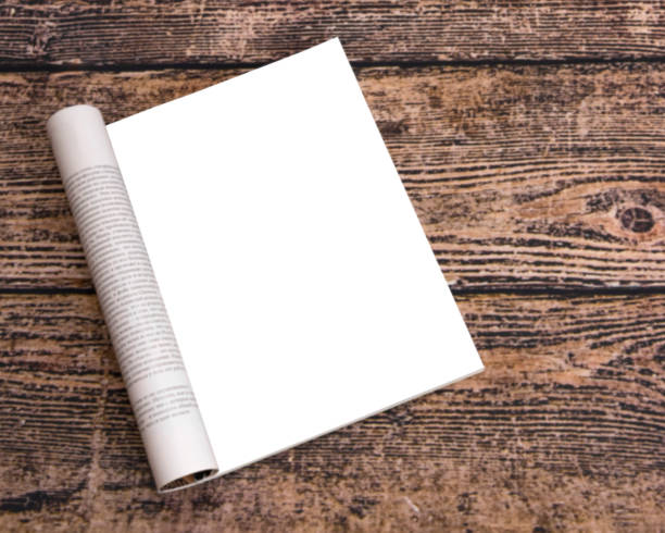 istock A magazine with clean sheets mock up on a wood background table. 1175911294