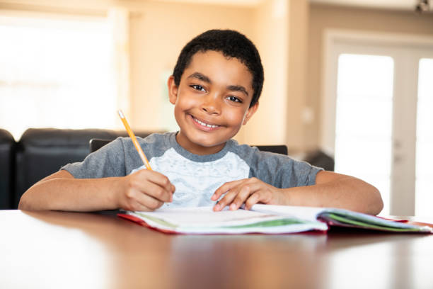 istock A male black child doing homework at home 1175911398