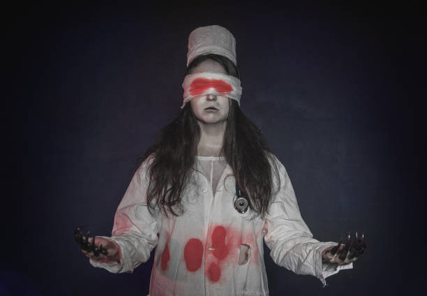 Terrible nurse woman with bloody bandage on her eyes. Halloween scene Terrible nurse woman with bloody bandage on her eyes. Halloween horror scene ugly people crying stock pictures, royalty-free photos & images