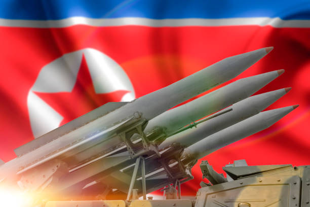 istock concept for rockets aimed upwards. flag north korea background. 1175911737
