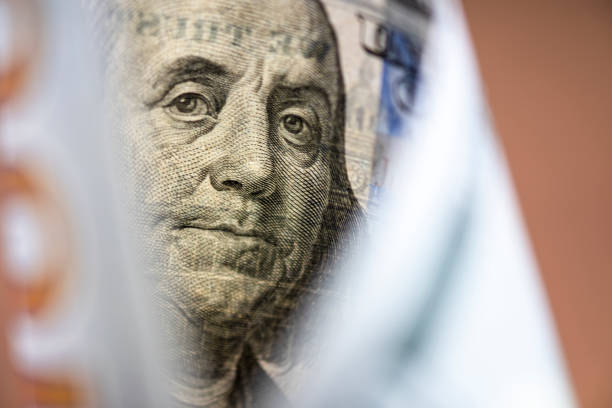 istock Benjamin Franklin face on US dollar banknote.US dollar is main and popular currency of exchange in the world.Investment and saving concept. 1175913151