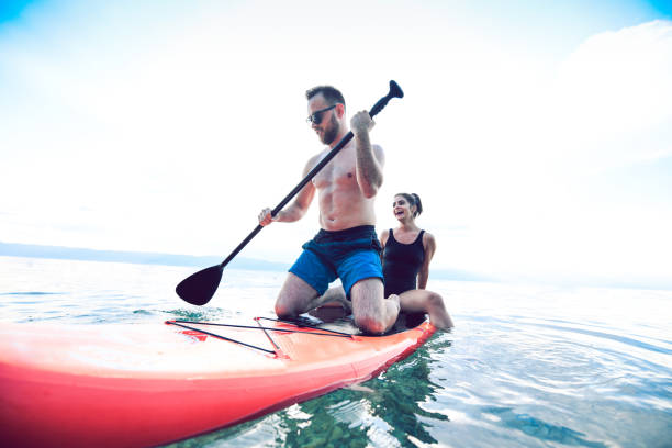 istock Couple Traveling The Lake With Only A Paddleboard 1175914446