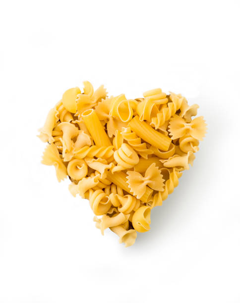 Heart shape heap of various pasta , isolated on a white background
