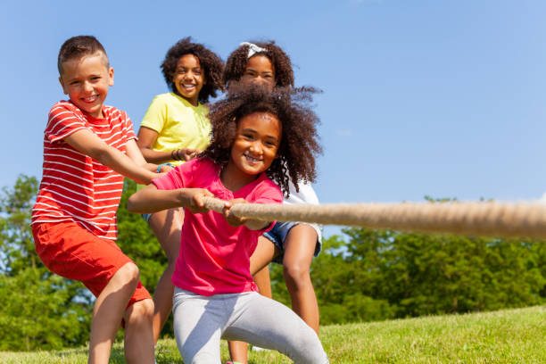 istock Girl with group portrait pull strong rope in game 1175916582