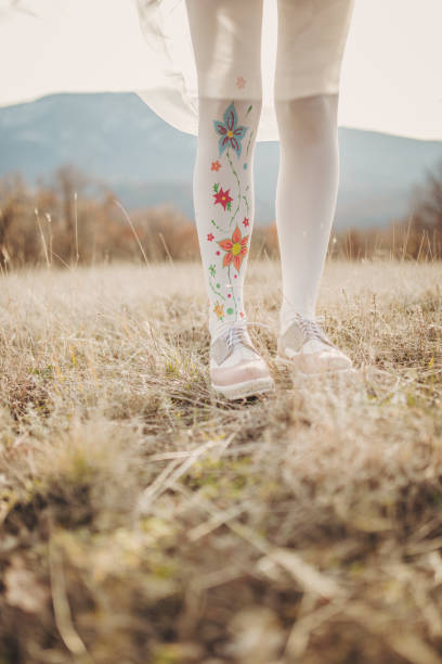 istock Woman in white stockings on a meadow 1175916603