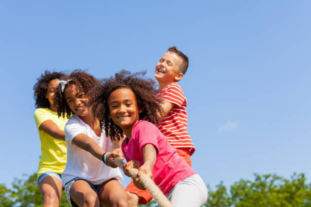 istock Boys and girls play pull cord in competitive game 1175916620
