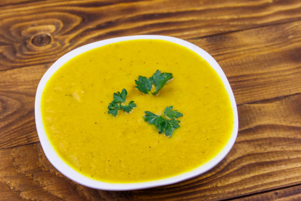 istock Pumpkin soup on a wooden table 1175916636