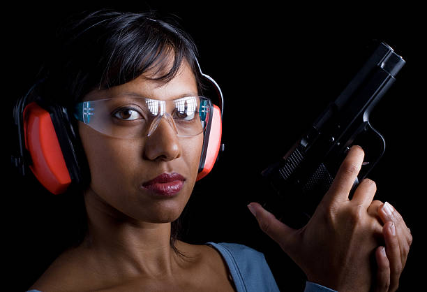 Woman at shooting range  headwear stock pictures, royalty-free photos & images