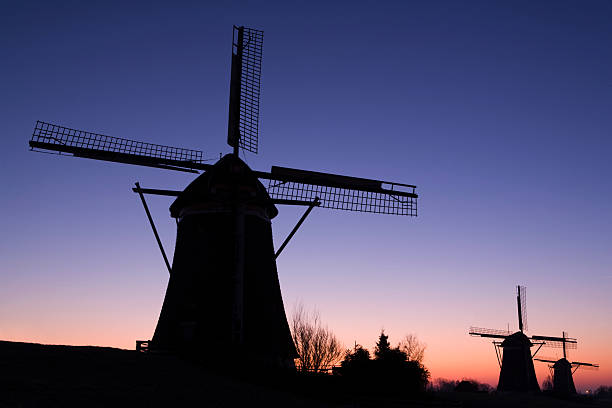 istock colorful sunrise behind some traditional Dutch windmills 117591782