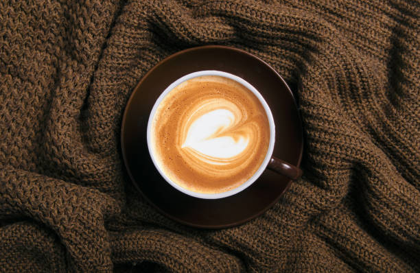 istock Cup of coffee and knitted brown sweater 1175920855