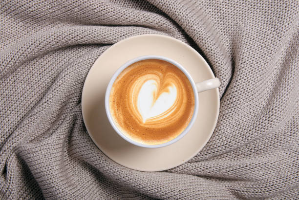 istock Cup of coffee and beige knitted sweater 1175920874