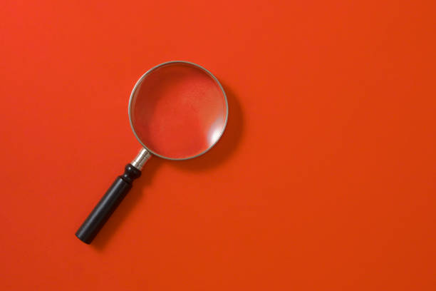 istock Magnifying Glass on Orange Background 1175921000