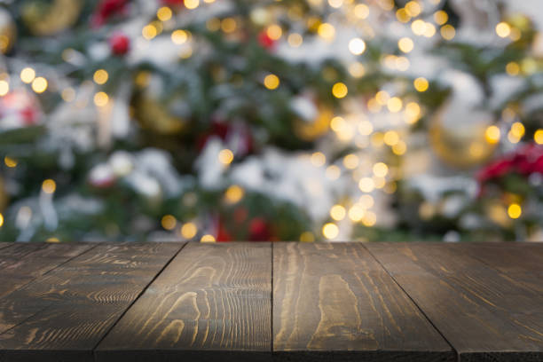 istock Wooden dark tabletop and blurred christmas tree bokeh. Xmas background for display your products. 1175921697