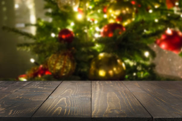 istock Wooden dark tabletop and blurred christmas tree bokeh. Xmas background for display your products. 1175921698