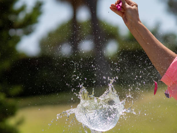 sequence in several photos of the launch of a dart against a water-filled balloon and its subsequent explosion. - rubber dart imagens e fotografias de stock