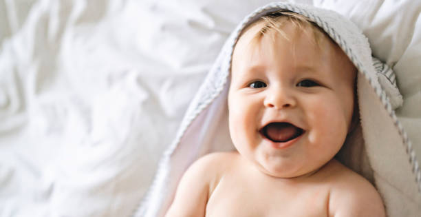 istock A cute Baby in white bedding at home 1175925076