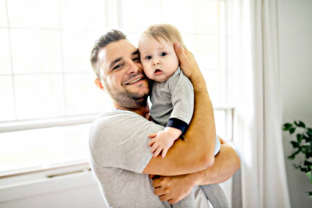 istock A Father with cute baby son on bed at home 1175925088