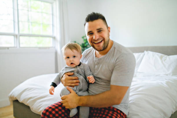 istock A Father with cute baby son on bed at home 1175925109