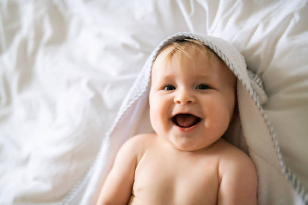 istock A cute Baby in white bedding at home 1175925112