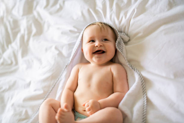 istock A cute Baby in white bedding at home 1175925156