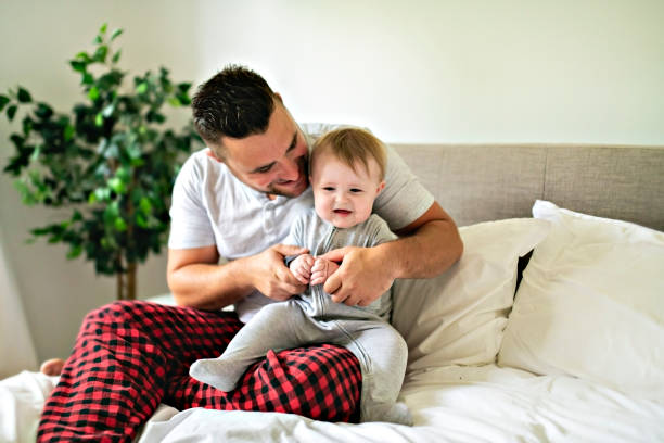 istock A Father with cute baby son on bed at home 1175925187