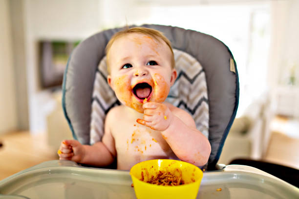 istock A Little baby eating her dinner and making a mess 1175925304