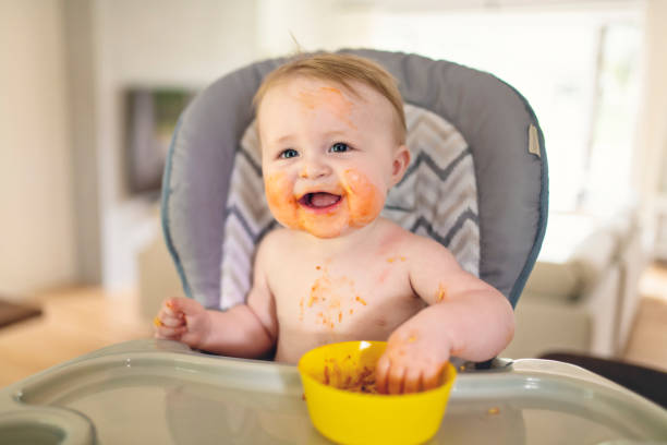 istock A Little baby eating her dinner and making a mess 1175925383