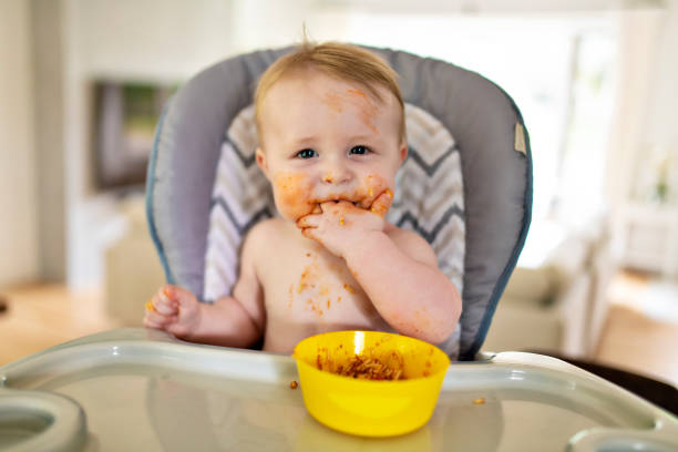 istock A Little baby eating her dinner and making a mess 1175925395