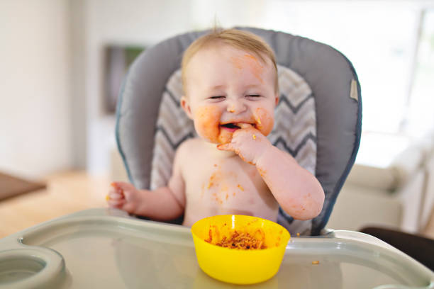 istock A Little baby eating her dinner and making a mess 1175925424