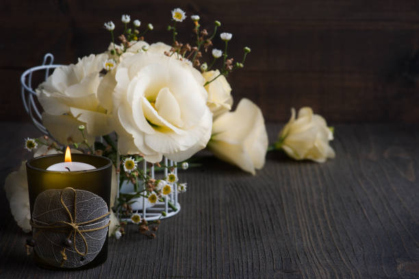 istock Yellow lisianthus flowers and lit candle 1175929123