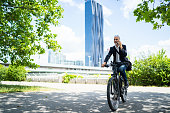 e-mobility commute to work businessman on electric bicycle