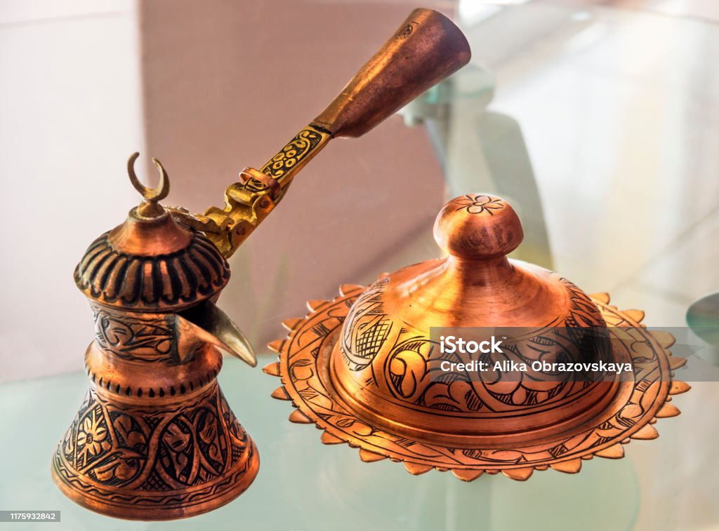 https://media.istockphoto.com/id/1175932842/photo/turkish-copper-coffee-pot-handmade-with-embossing-and-turkish-candy-with-a-national-pattern.jpg?s=1024x1024&w=is&k=20&c=s2A0wf-LEuxkLCB0Me1WbXC9bMVvpPhXnkfA8GLO5wU=