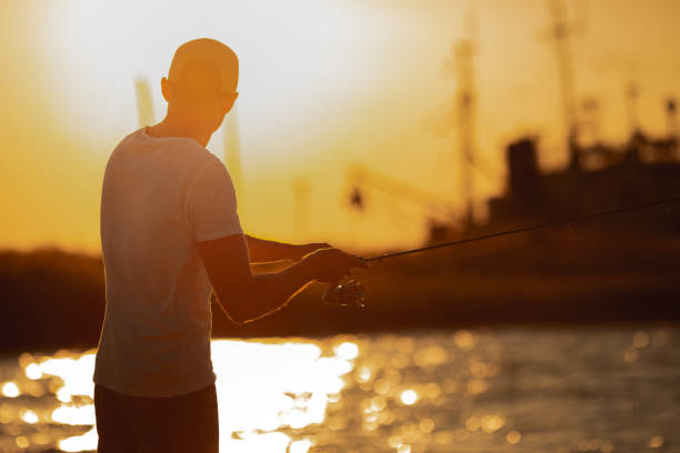 istock Young man fishing at sea 1175933148