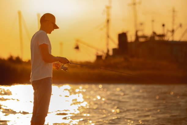 istock Young man fishing at sea 1175933201