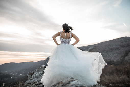 Bride standing on the top of the mountain