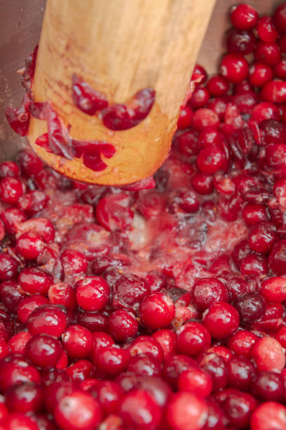 istock Crush the red cranberry berries with a wooden rolling pin 1175934706