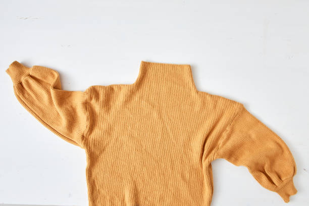 istock knitted yellow sweater on white table wooden 1175936379