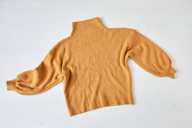 istock knitted yellow sweater on white table wooden 1175936392