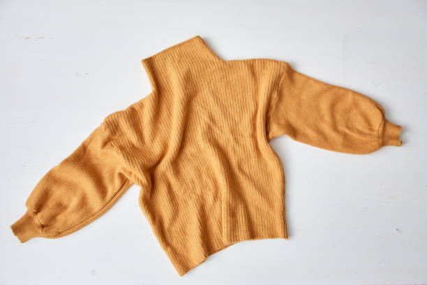 istock knitted yellow sweater on white table wooden 1175936396